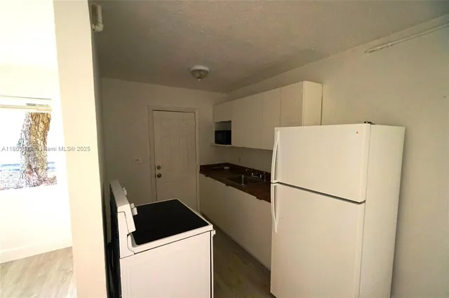 a kitchen with a refrigerator and a stove