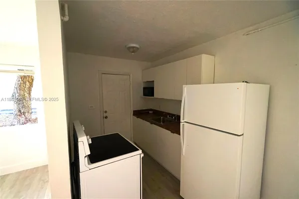a kitchen with a refrigerator and a stove