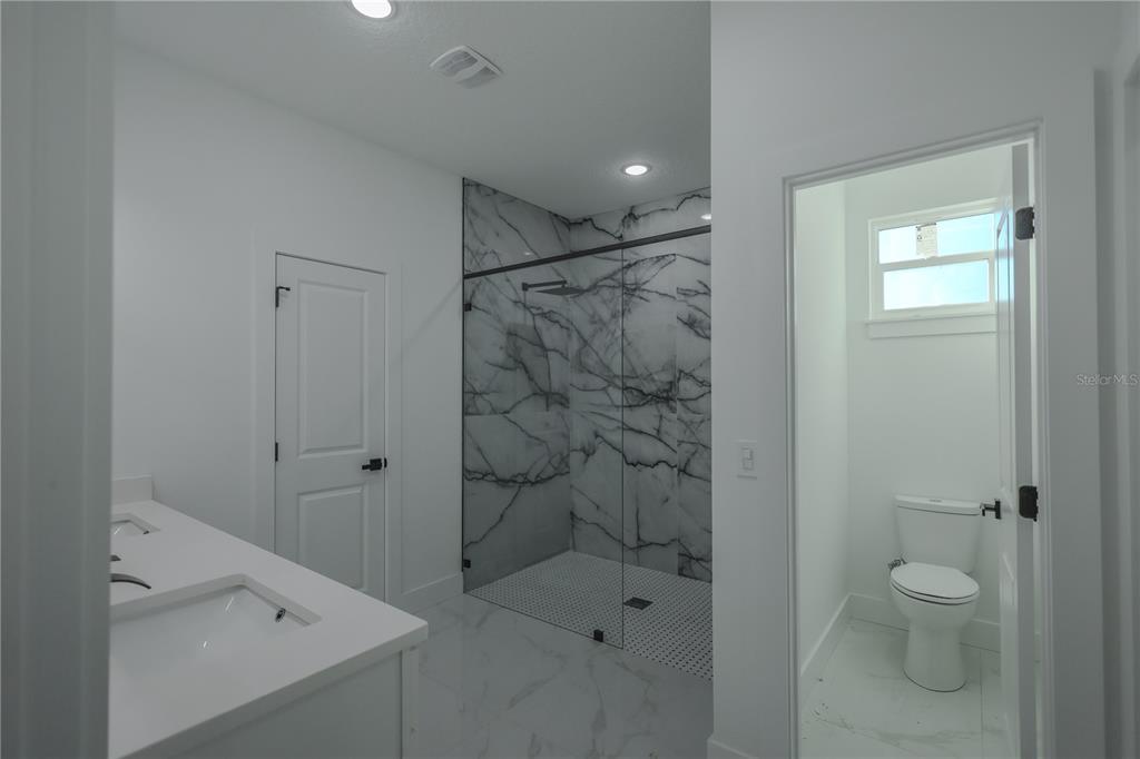 1808 Corolla Court Deltona, FL 32738 - Photo 15 of 29 a bathroom with a shower and a toilet