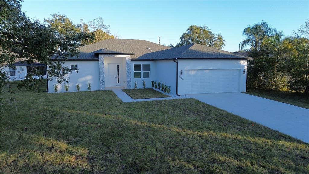 1808 Corolla Court Deltona, FL 32738 - Photo 2 of 29 a front view of a house with a yard and garage