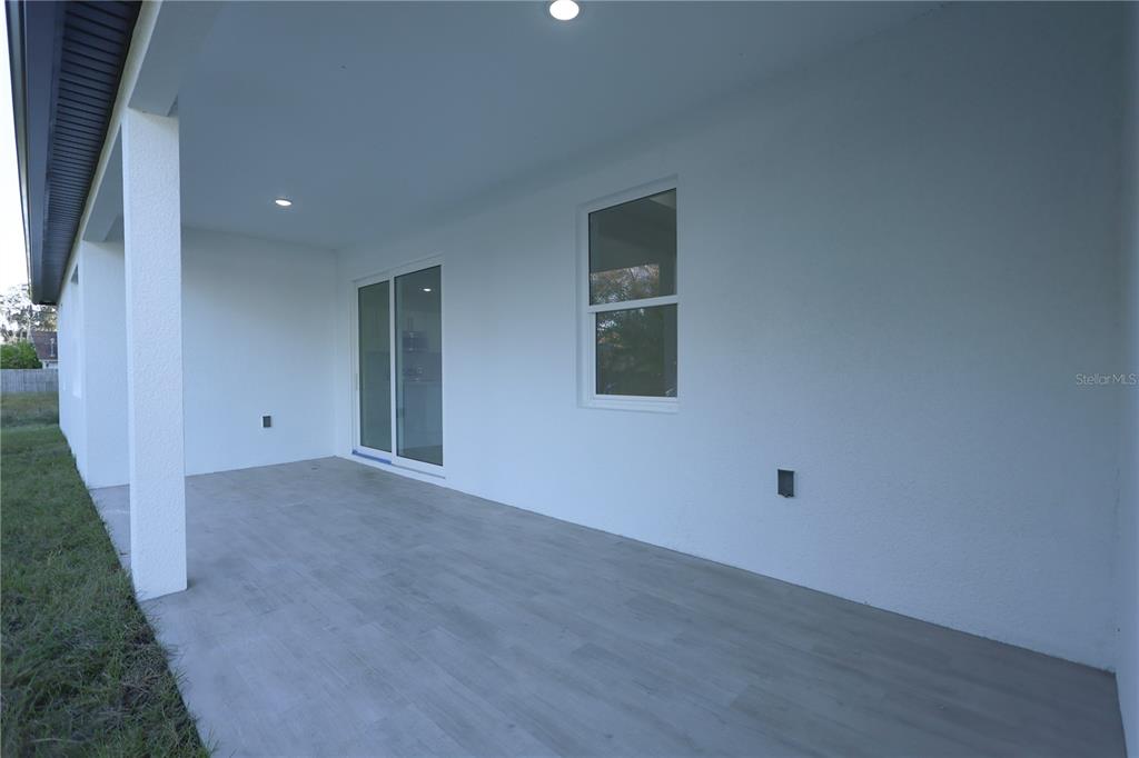 1808 Corolla Court Deltona, FL 32738 - Photo 26 of 29 a view of an empty room with wooden floor and a window