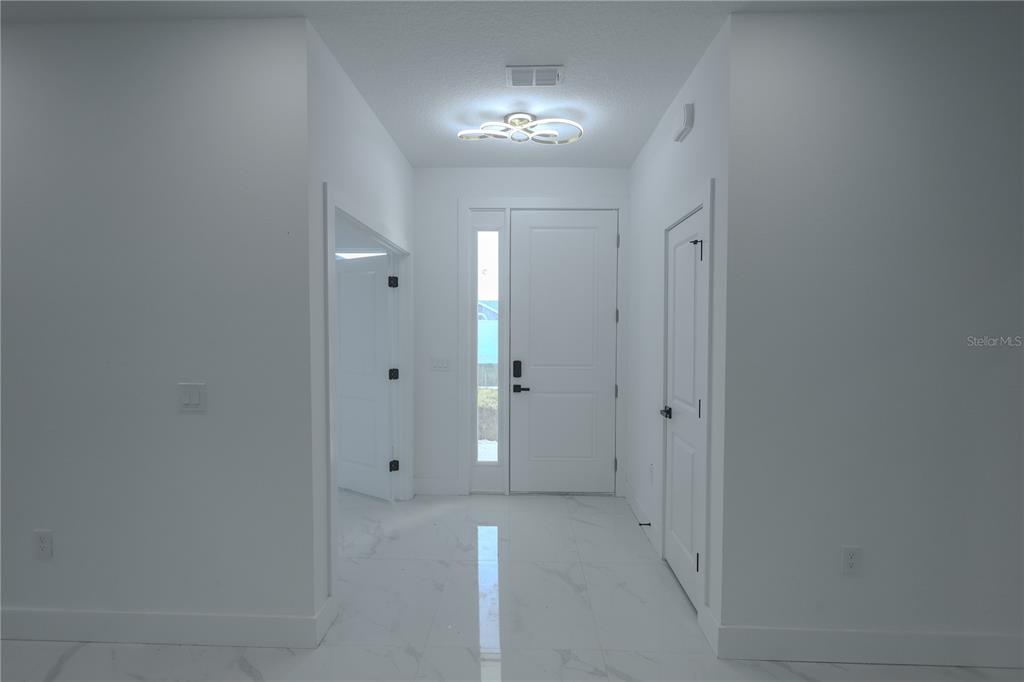 1808 Corolla Court Deltona, FL 32738 - Photo 3 of 29 wooden floor in a room with a mirror