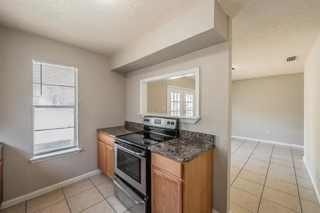 a kitchen that has a stove and a window