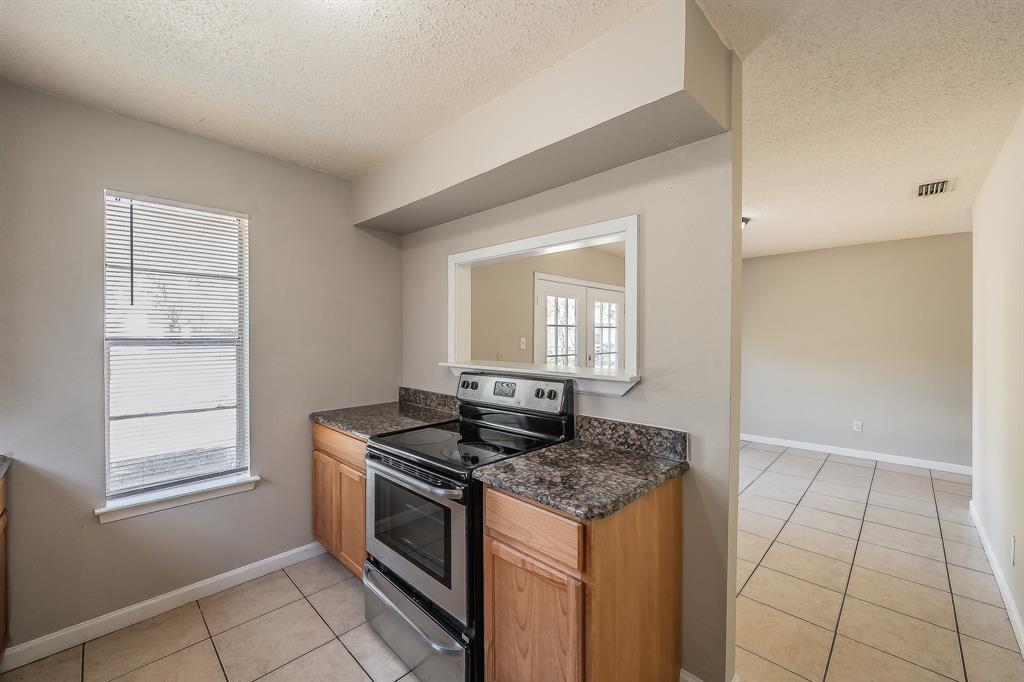 3029 Montclair Place Denton, TX 76209 - Photo 11 of 39 a kitchen that has a stove and a window