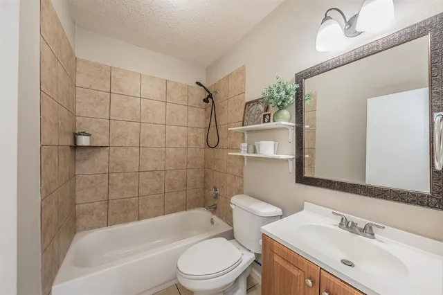 a bathroom with a toilet a sink and mirror