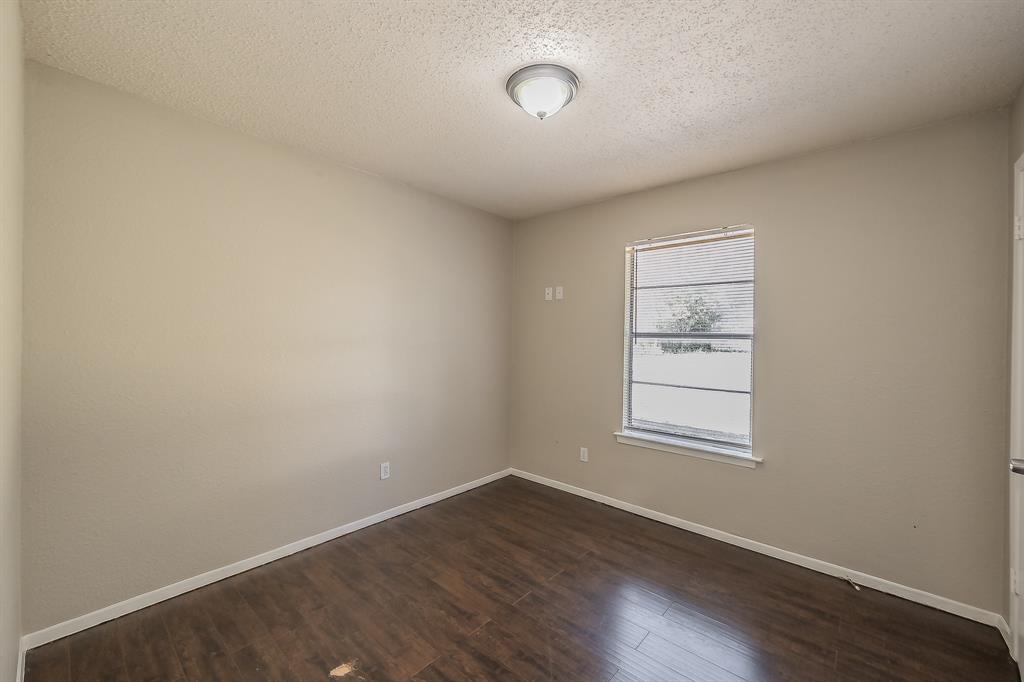3029 Montclair Place Denton, TX 76209 - Photo 21 of 39 an empty room with wooden floor and windows