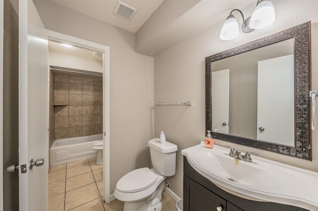 3029 Montclair Place Denton, TX 76209 - Photo 25 of 39 a bathroom with a sink a toilet and shower