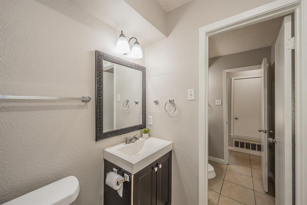 3029 Montclair Place Denton, TX 76209 - Photo 28 of 39 a bathroom with a sink a toilet and mirror