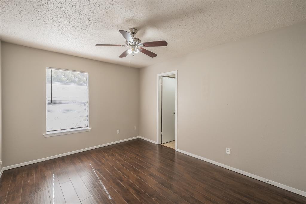 3029 Montclair Place Denton, TX 76209 - Photo 31 of 39 an empty room with wooden floor fan and windows