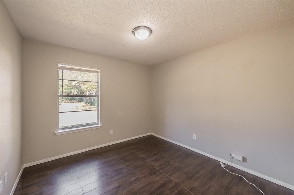 3029 Montclair Place Denton, TX 76209 - Photo 32 of 39 an empty room with wooden floor and windows