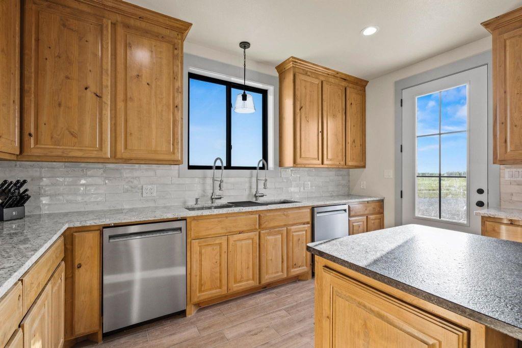 4251 Refuge Road Sherman, TX 75092 - Photo 21 of 40 a kitchen with stainless steel appliances granite countertop wooden cabinets a sink and dishwasher