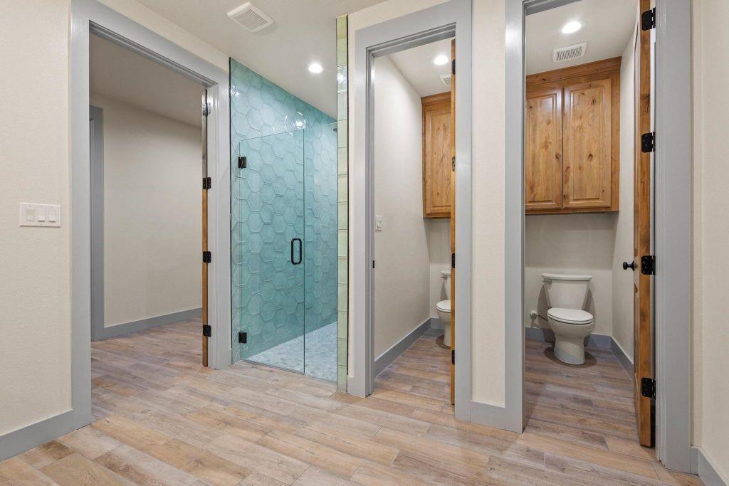 4251 Refuge Road Sherman, TX 75092 - Photo 25 of 40 a view of a bathroom with a glass shower door and a bathroom