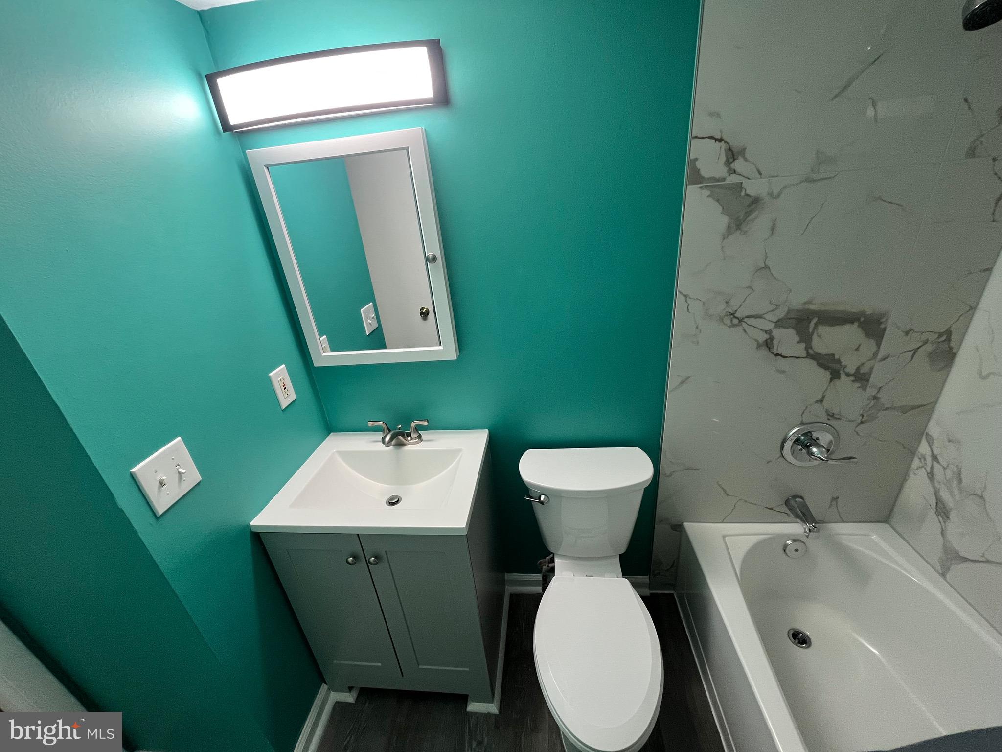 8607 Village Way, Unit 7/8607F Alexandria, VA 22309 - Photo 14 of 30 a bathroom with a toilet sink and mirror