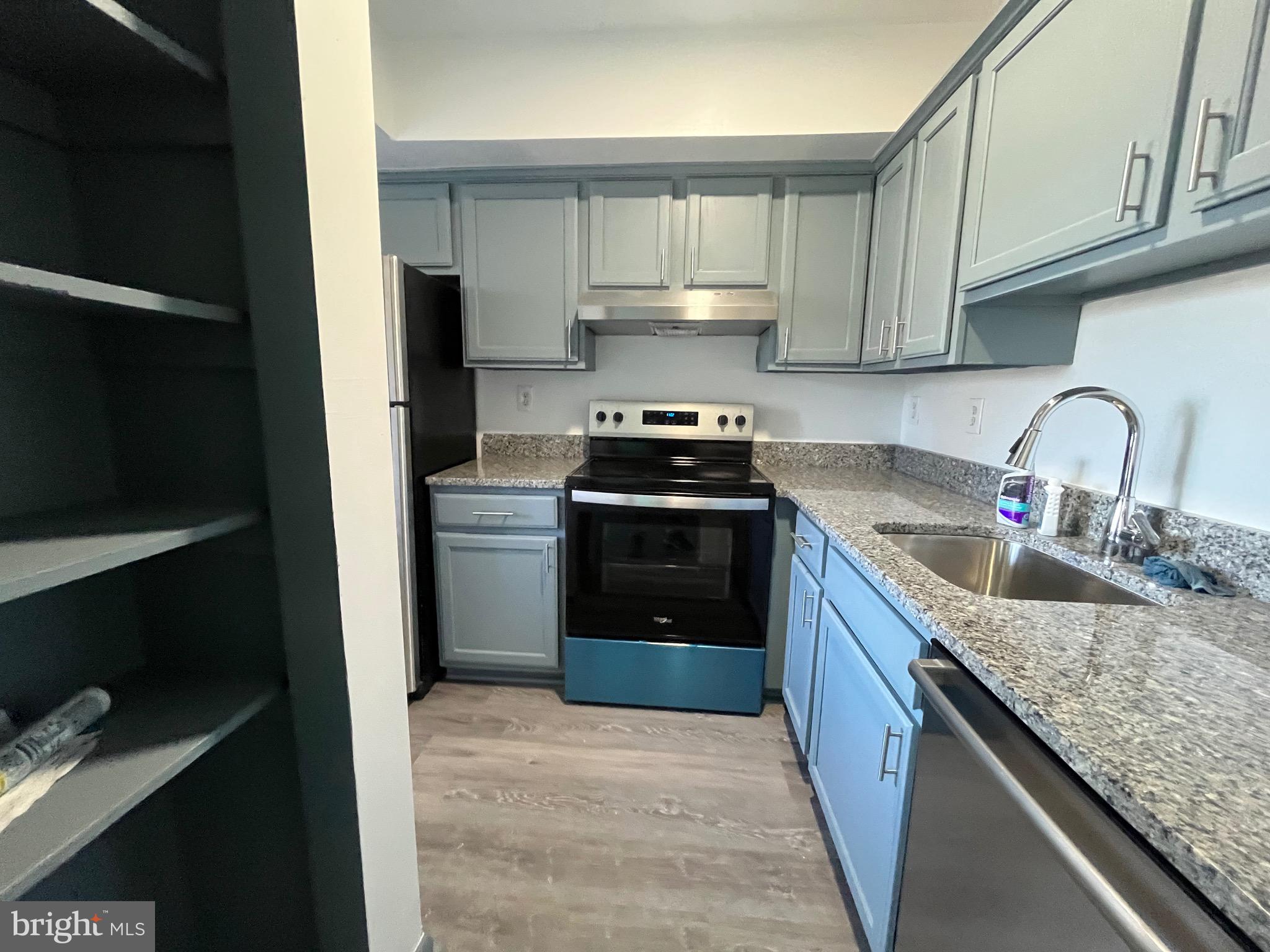 8607 Village Way, Unit 7/8607F Alexandria, VA 22309 - Photo 5 of 30 a kitchen with granite countertop a sink stove and refrigerator