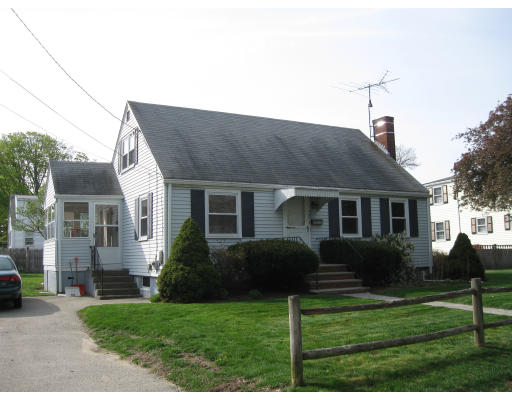 a front view of house with a garden