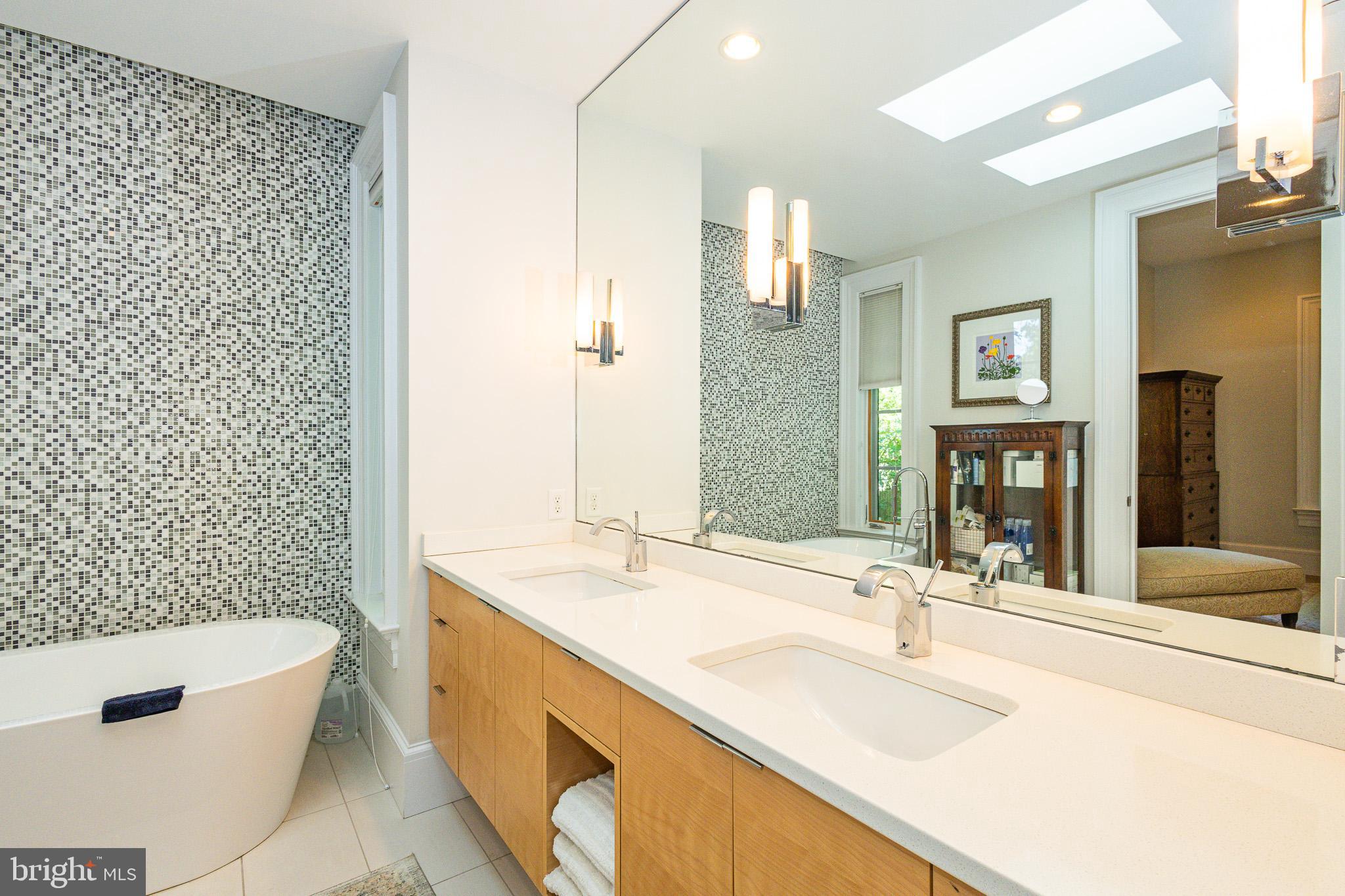 1004 Moss Haven Court Annapolis, MD 21403 - Photo 37 of 77 a bathroom with a granite countertop tub a sink and a large mirror