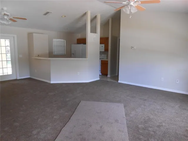 en empty room with windows and entrance