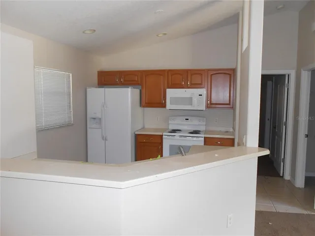 a kitchen with stainless steel appliances a refrigerator and a stove