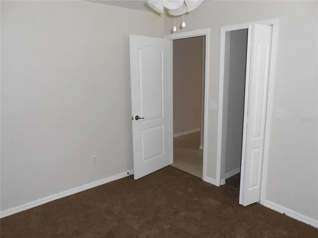 an empty room with closet area