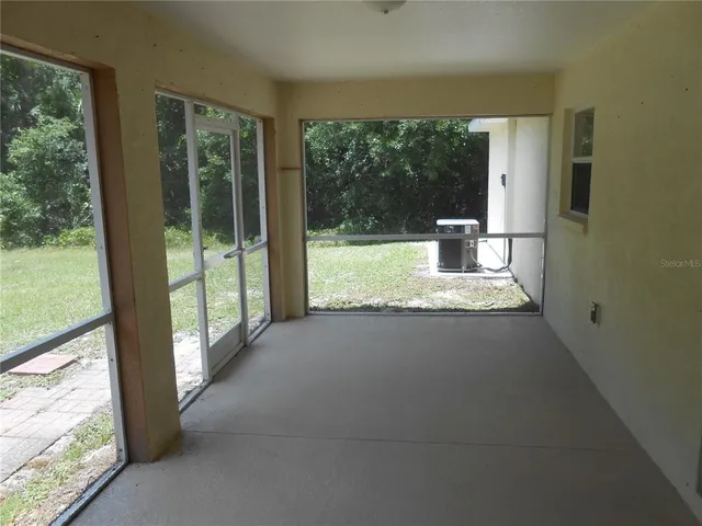 a view of a living room and floor to ceiling window