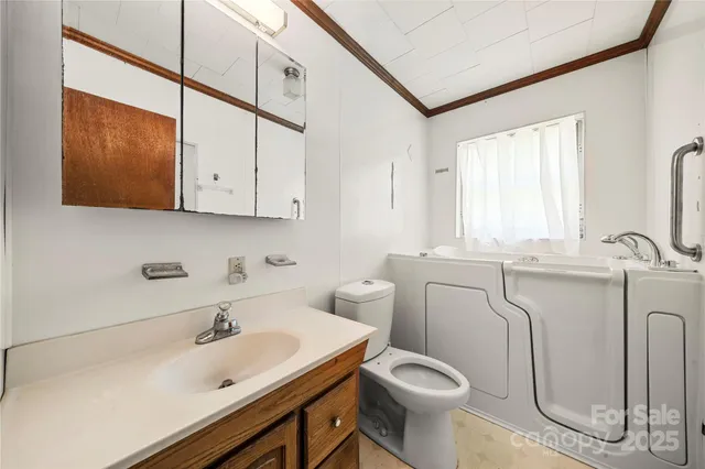 a bathroom with a sink toilet and mirror