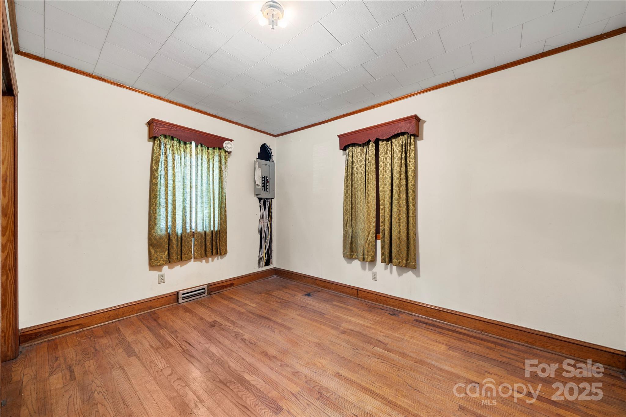 505 Rogers Lake Road East Kannapolis, NC 28083 - Photo 14 of 33 an empty room with wooden floor and windows