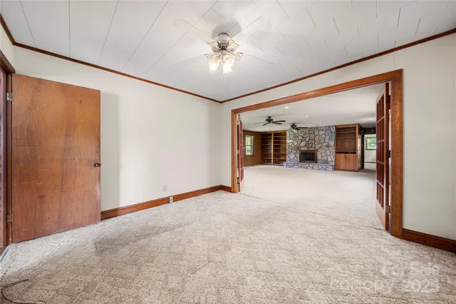 a view of an empty room with a ceiling fan