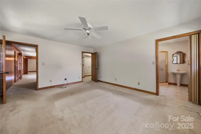 a view of empty room with ceiling fan