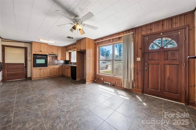 a view of a kitchen with a sink and a refrigerator