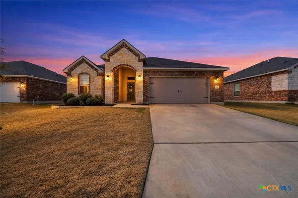a front view of a house with yard
