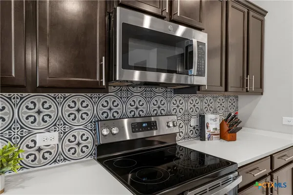 a kitchen with a stove and cabinets