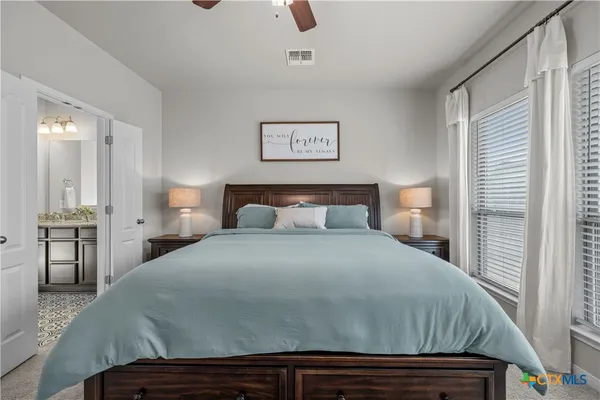 a bedroom with a bed and a night stand