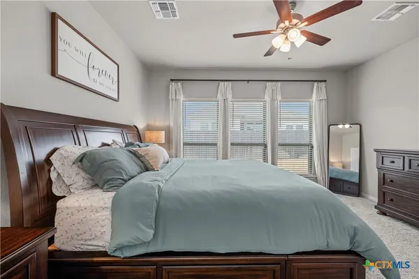 a bedroom with a large bed and a tv