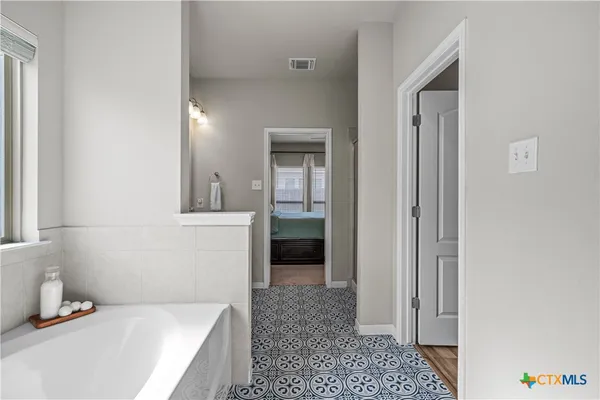 a bathroom with a bathtub and shower