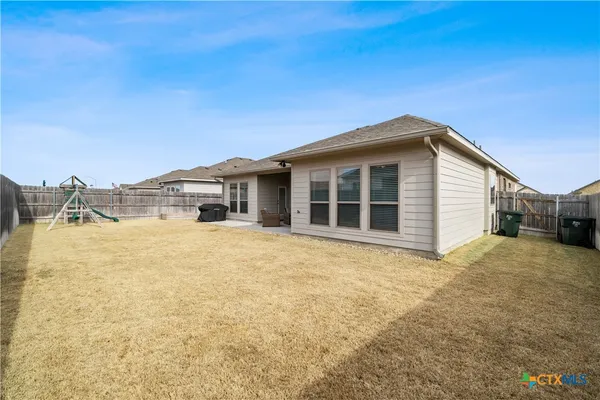 a view of a house with a backyard