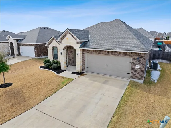 an aerial view of a residential houses with outdoor space