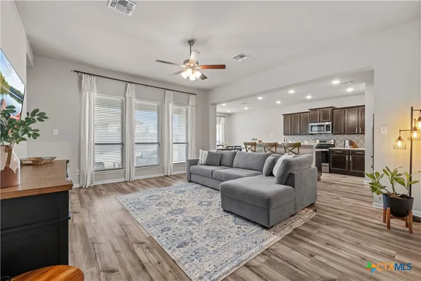 a living room with furniture and a large window