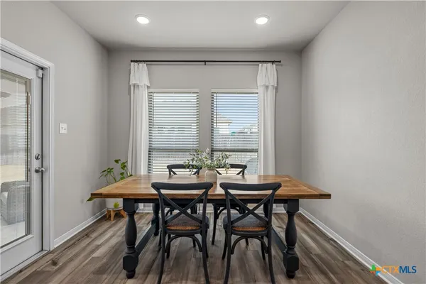 a view of a dining room with furniture and window