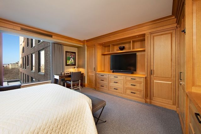 a bedroom with a bed and flat screen tv