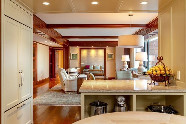 a living room with fireplace furniture and a potted plant