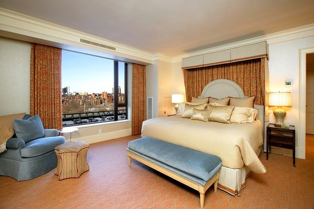 a bedroom with a bed and large window