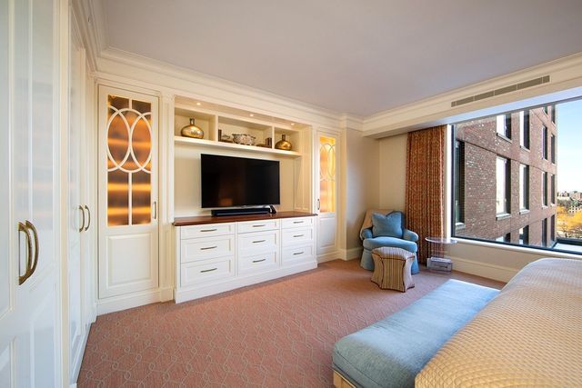 a bedroom with furniture and a flat screen tv