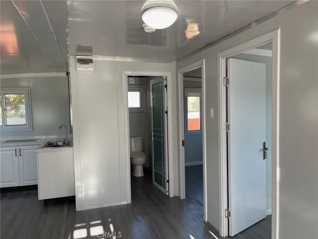 a view of a room with wooden floor and cabinet