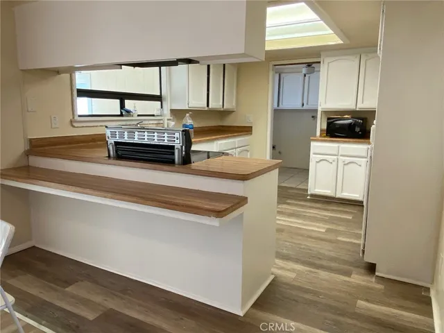a kitchen with stainless steel appliances a stove microwave and cabinets