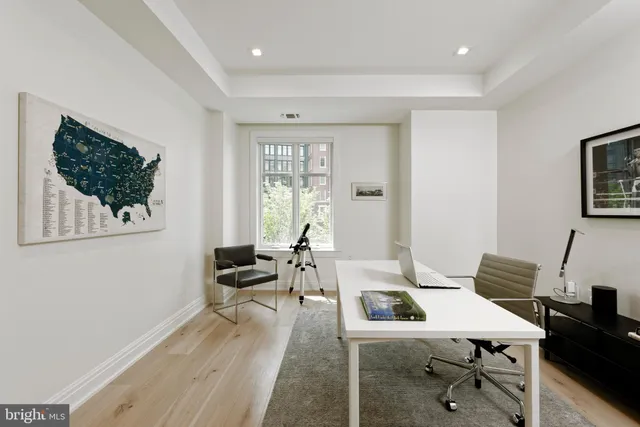 a living room with furniture a flat screen tv and a window