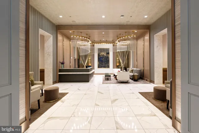 a lobby with furniture and large windows