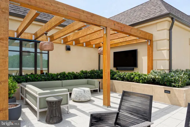 a view of a patio with couches table and chairs and potted plants