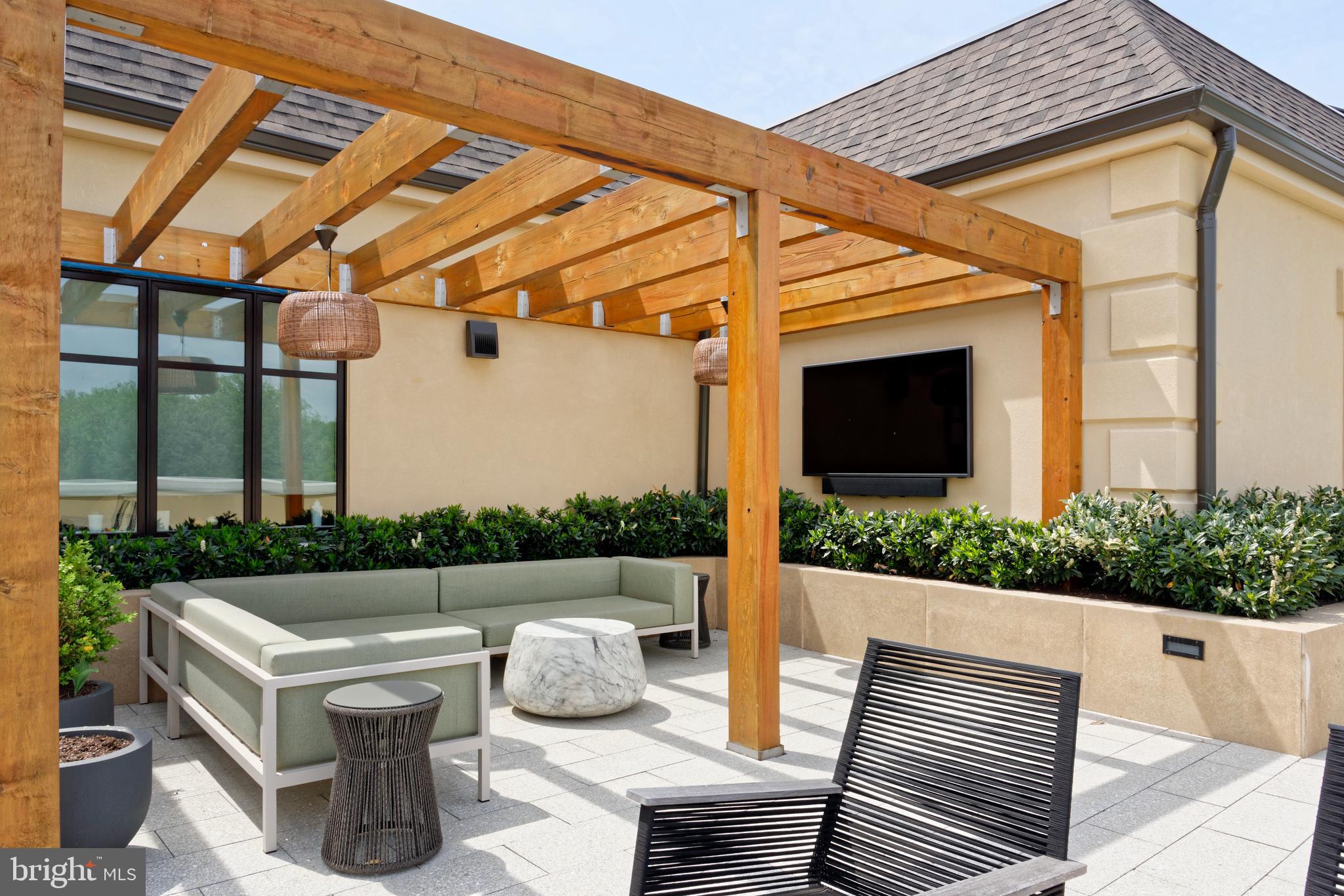 8551 Connecticut Avenue, Unit 207 Chevy Chase, MD 20815 - Photo 25 of 33 a view of a patio with couches table and chairs and potted plants