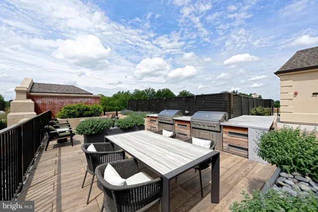 a roof deck with a table and chairs