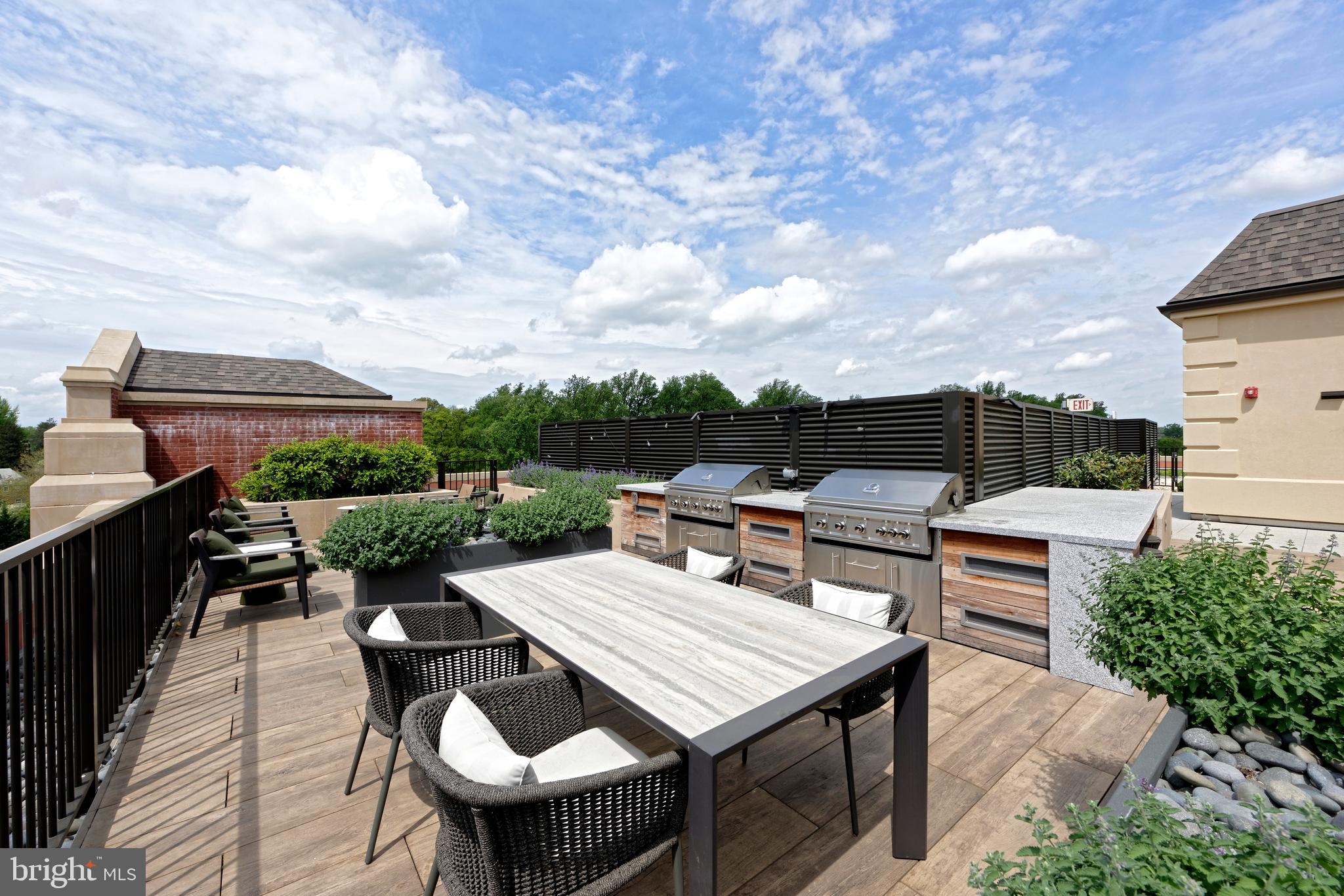 8551 Connecticut Avenue, Unit 207 Chevy Chase, MD 20815 - Photo 27 of 33 a roof deck with a table and chairs